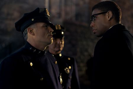 Malcolm X, played by Aaron Pierre, faces off with police officers in GENIUS: MLK/X. (National Geographic/Josh Stringer)