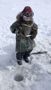 Asher Ulroan ice fishing with his grandparents. (National Geographic/Matt Kynoch)
