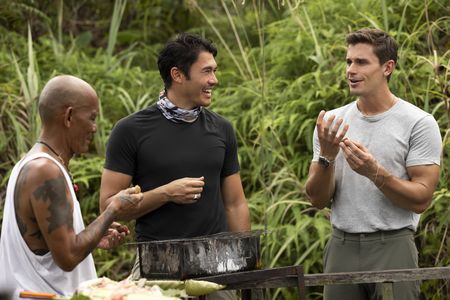 Henry Golding and Antoni Poroski try buah maram or sour palm. (Credit: National Geographic/Annice Lyn)