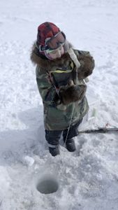 Asher Ulroan ice fishing with his grandparents. (National Geographic/Matt Kynoch)
