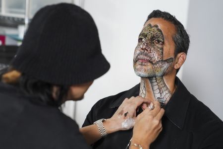 Amazing Jiro paints a reptile effect on David Blaine's face and neck.   (credit: National Geographic/Dana Hayes)