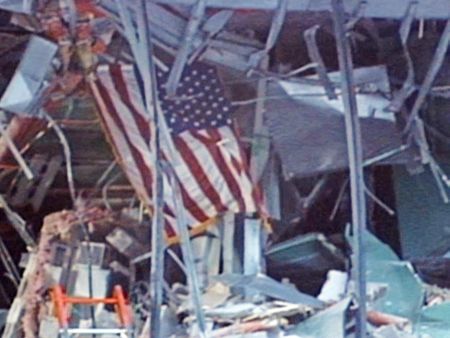 A US flag is seen among the remains of the Alfred P. Murrah Federal Building on the evening of April 19, 1995, in Oklahoma City, Okla. (KFOR-TV)