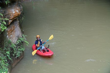 Christian Cooper and Jorge emerge from the subterranean cave in their kayaks on their way to find the endmeic Puerto Rican Tody. (National Geographic for Disney)