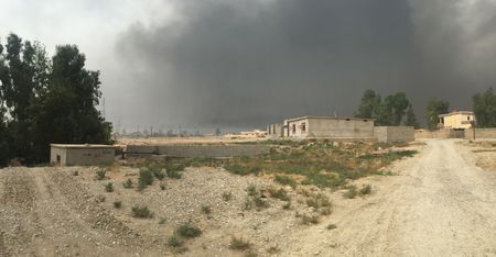 QAYARRAH, IRAQ - After leaving Qayarrah, ISIS sets oil fires as a parting gift for the villagers. (photo credit: Junger Quested Films LLC/Nick Quested)