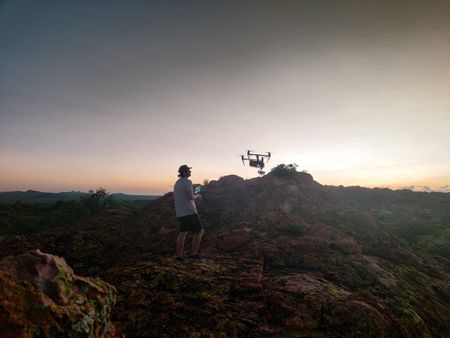 Ollie Lane pilots a drone to film the sunrise at Maremani Nature Reserve. (National Geographic for Disney/Alex Minton)
