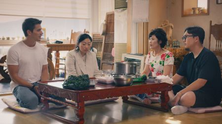 Antoni Porowski, Awkwafina, Hyeonsook Kwon, and Junho Lee at Mrs. Kwon's house making seaweed soup. (National Geographic)