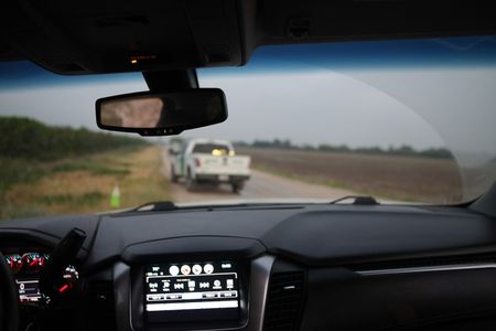 A Border Patrol vehicle is parked on a road near the border wall in the Rio Grande Valley, Texas. (National Geographic)