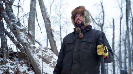 Chevie Roach prepares his fish nets to set under the ice. (BBC Studios/Brian Bitterfeld)