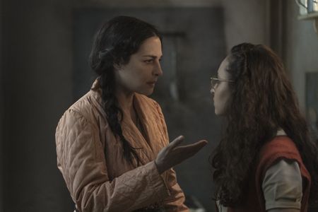 A SMALL LIGHT - Edith Frank, played by Amira Casar, speaks with her daughter Margot, played by Ashley Brooke, in the annex as seen in A SMALL LIGHT. (Credit: National Geographic for Disney/Dusan Martincek)
