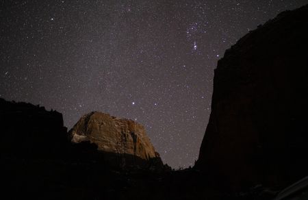 The Orion constellation, envisioned as a hunter in Southern Paiute astronomy, makes an appearance from behind the cliffs of Zion Canyon. (National Geographic/Jeff Reed)