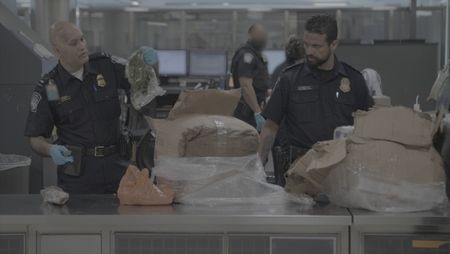 CBP Officers Islam and Hundal use knives to inspect a passenger's boxes, searching for customs violations at the Dulles International Airport in Dulles, Va. (National Geographic)