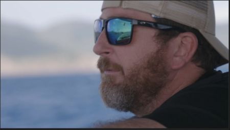 CBP AMO Agent Jeff is looking out over the water while running an operation in Fajardo, P.R. (Lucky 8 TV/Paul Taggart)