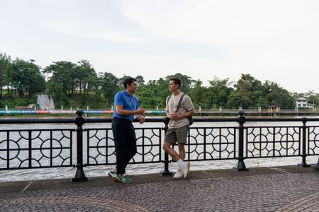 Henry Golding and Antoni Porowski on the waterfront in Kuching. (National Geographic/Rebecca Eishow)