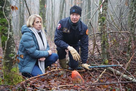 Alex Churchill and Guy Mom per from the Metz demining center inspect an unexploded munition in the "Red Zone" forest near Verdun, France. An area where an estimated 8 million shells fell without exploding during WW1. Many shells still remain untouched in the forest. (National Geographic/Ciaran Henry)