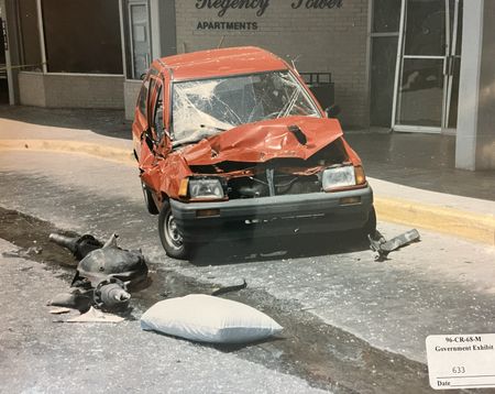 The axle from the Ryder Truck used in the Oklahoma City Bombing, is seen next to a damaged car, outside the Regency Tower, April 19, 1995, in Oklahoma City, Okla. (FBI)