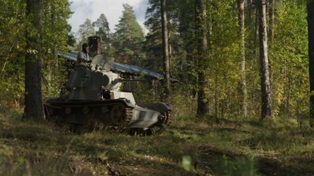 A man on a tank in the woods. (National Geographic)