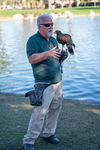 Expert falconer, Ken Miknuk, holds Bond, his trained Harris’ Hawk and “best friend.” (National Geographic/Jon Kroll)