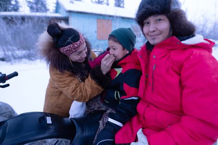 Wade Kelly with his mother, Iriqtaq, and grandmother, Agnes Hailstone, heading to an elder's home to give away his first ptarmigan. (BBC Studios Reality Productions, LLC/Ashton Hurlburt)