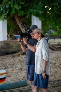 Cinematographer, Rory McGuinnes, and Algae octopus expert, Dr. Crissy Huffard, prepare to film on the shores of Siladen Island in Bunaken Marine Park.  (photo credit: National Geographic/Annabel Robinson)