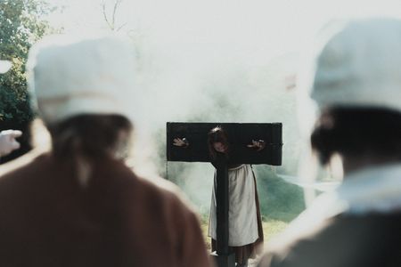 One of the accused women stands locked in a pillory, looked upon by female villagers in the foreground.(Dash Productions Services LTD/Antoan Ivanov)