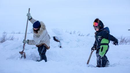 Agnes Hailstone and her grandson, Sabastian shovel snow to prepare their camp. (BBC Studios Reality Productions/Ashton Hurlburt)