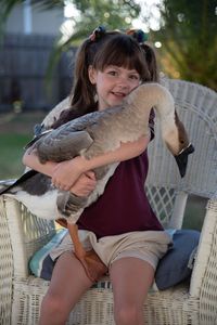 A goose being hugged by a child. (Big Wave Productions)