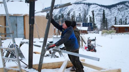 Andy Bassich and Denise Becker construct solar array panels for their property. (BBC Studios/Ben Mullin)