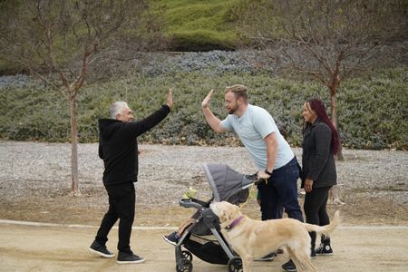 Cesar high fives Derek as the family looks on.  (National Geographic)