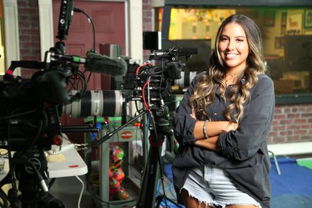 Heidy Martinez smiling with arms crossed next to video equipment. (National Geographic/Robert Toth)