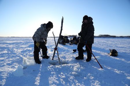 Brothers, Avery and Gage Hoffman set fish nets under the ice for subsistence food for their family and community. (BBC Studios Reality Productions, LLC/Isaiah Branch - Boyle)