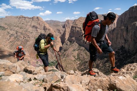 Jimmy Chin, director / DP, Dave Allfrey, rigger, and Mikey Schaefer carry 50lb packs 6-7 miles into the mountains and up over 3000ft of gain to one of the shooting positions in Morocco. Once there, they will organize gear, build anchors, rappel into position, build cameras, shoot for the day, climb back out, pull ropes, repack and hike out. They will have an 18 hour day.  (National Geographic/Cheyne Lempe)