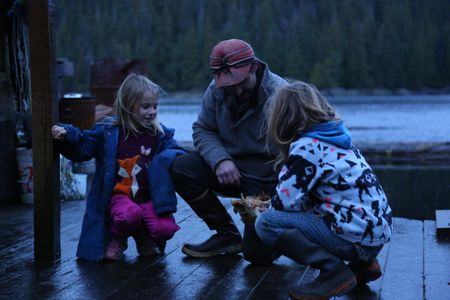 Cole Sturgis with his daughters, Timber and Willow on their float house. (BBC Studios Reality Productions, LLC/Lukas Taylor)