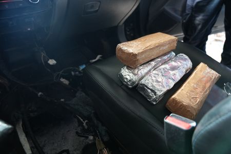 Multiple packages of suspected narcotics are pictured on the driver's seat of a suspect's vehicle after they were found smuggled inside in Brownsville, Texas. (National Geographic)