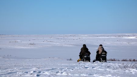 Gage and Avery travel by snowmobile, on the lookout for moose. (BBC Studios Reality Productions, LLC/Jeffrey Alexander)