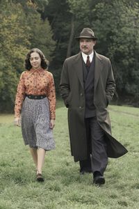 A SMALL LIGHT - Miep Gies, played by Bel Powley, walks with Otto Frank, played by Liev Schreiber, as seen in A SMALL LIGHT. (Credit: National Geographic for Disney/Dusan Martincek)