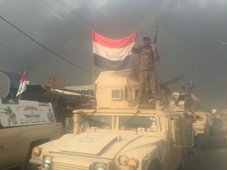 QAYARRAH, IRAQ - Iraqi forces celebrate the ousting of ISIS. (photo credit:  Junger Quested Films LLC/Nick Quested)