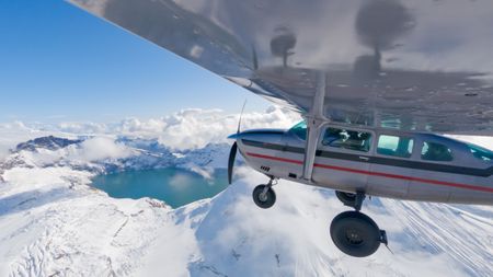 A plane flying over Mount Martin. (credit: National Geographic/Jeff Reed)