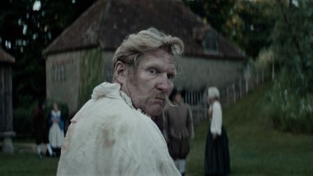 Dietrich Flade looking back in fear. Three villagers stand together in the backgorund. (Dash Pictures/Samuel Purcell, Oliver Watts)