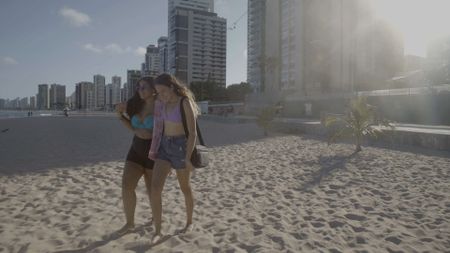 Kaylanne Timoteo Freitas and her friend, Emily, walking across Piedade Beach. (National Geographic/Ed Davies)