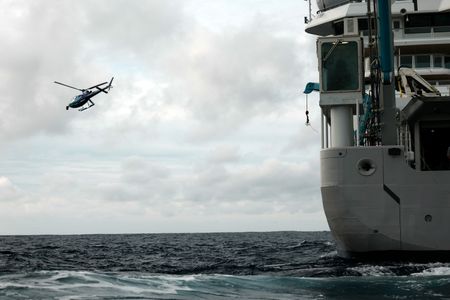 The helicopter flies next to OceanXplorer. (National Geographic/Mario Tadinac)