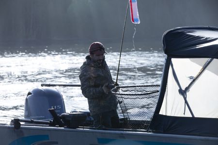Cole Sturgis successfully catches a winter king salmon for subsistence food. (BBC Studios Reality Productions, LLC/Lukas Taylor)
