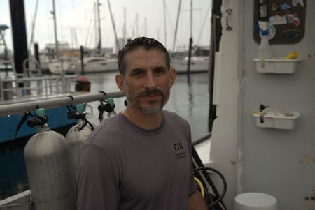 Scientist Dr. Yannis Papastamatiou on the docks at Riviera Beach. (National Geographic/Lisa Tanner)