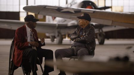 Tuskegee Airmen LT. COL. (RET) Harry T. Stewart, Jr., and Tuskegee Airman LT. COL. (RET) James H. Harvey chat at the Tuskegee Airmen National Museum in Detroit. (National Geographic)
