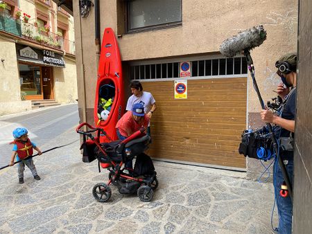 Gerd Serrasolses, Ali Casas, and their children get kayaks out from the garage on their way to the river in Sort, Spain.  (National Geographic/Gene Gallerano)