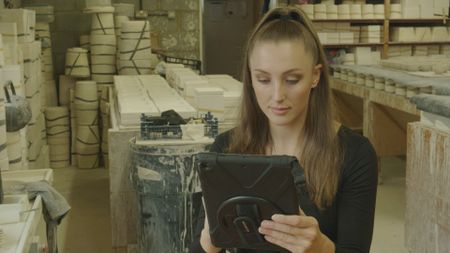 In this behind-the-scenes photo, cuneiform archaeology expert Lara Bampfield prepares some slides on her iPad. (Windfall Films)