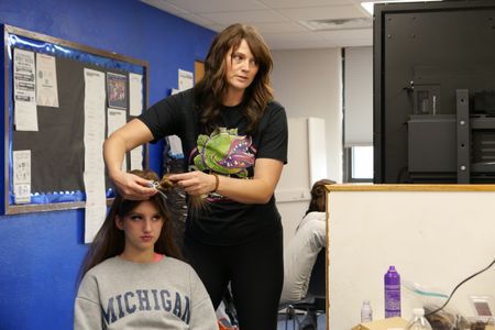 Dr. Erin Schroeder fulfills her duties as stage mom by working on student Sophie's hair before the school musical. (National Geographic)