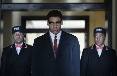 Malcolm X, played by Aaron Pierre, is escorted from Temple in GENIUS: MLK/X. (National Geographic/Richard DuCree)