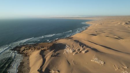 An aerial view of the film crew's camp set in the rolling dunes of the Namib desert on the Skeleton coast at the foot of Sylvia Hill.  (credit: National Geographic/Tom Beldam)