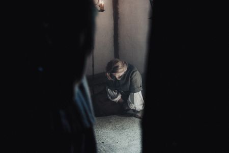 Agnes Sampson sits shackled and defeated in her prison cell. (Dash Productions Services LTD/Antoan Ivanov)