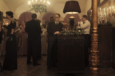A SMALL LIGHT - Jan Gies, played by Joe Cole, attends a party as seen in A SMALL LIGHT. (Credit: National Geographic for Disney/Dusan Martincek)